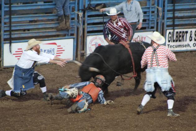 A rodeo clown intervenes just as the bull is head to head with Ryker Butler of McLoud during the second round of the IFYR on July 12. Butler won the event with an average score of 167.5 points for three rides. Countywide &amp; Sun/Natasha Dunagan