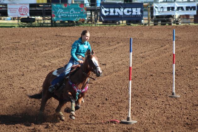 Paislee Fugate of Backburnett, TX, makes the end turn in the second round of Pole Bending at the IFYR on July 13. Countywide &amp; Sun/Natasha Dunagan