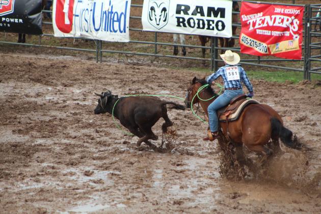 Kasey Keys of Shawnee doesn't give up on roping his steer, while riding through deep mud.