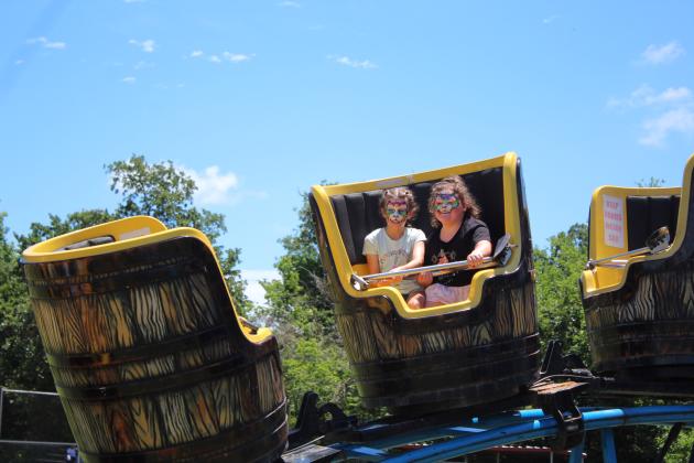 Fourth generation McLoud residents, Alexandra Ellis, 10, and Hadley McGuffin, 6, enjoy a "barrel" ride during the McLoud Blackberry Festival on July 8. Countywide &amp; Sun/Natasha Dunagan