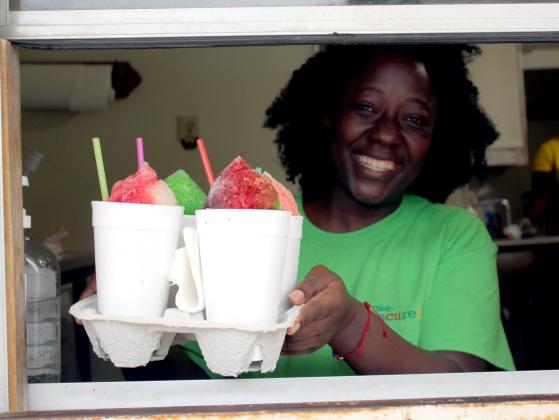Tarryn Henry serves up an order for four snow cones at Epic Sno Cones, at 722 S. Beard on July 3. The oldest stand in Shawnee is still operating out of the building where it began in 1952, and David Henry, Tarryn's father, opened for the summer on June 1. Countywide &amp; Sun/Natasha Dunagan