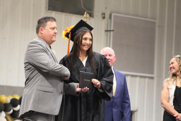 Maud Graduation - Maud School Board Member Kurt Dustman presents a diploma to his daughter Maddie Dustman.