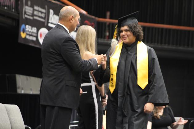 Tecumseh graduate Brayden Deer gets a fist bump from Athletic Director Jeff Shafer at graduation on May 17. Countywide &amp; Sun/Natasha Dunagan