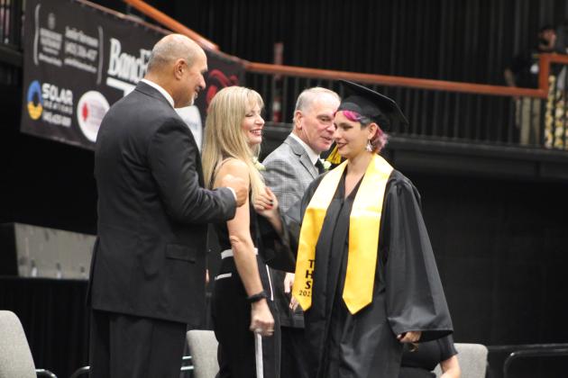 Tecumseh Athletic Director Jeff Shafer gets a fist bump from graduate Allissa Dunagan at graduation on May 17. Countywide &amp; Sun/Natasha Dunagan