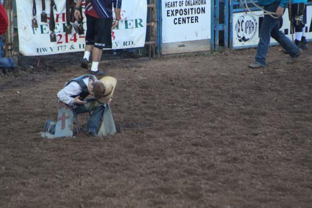 Mitchie Storie of Aztec, NM, says a prayers after his saddle bronc ride during the IFYR finals on July 14. Countywide &amp; Sun/Natasha Dunagan