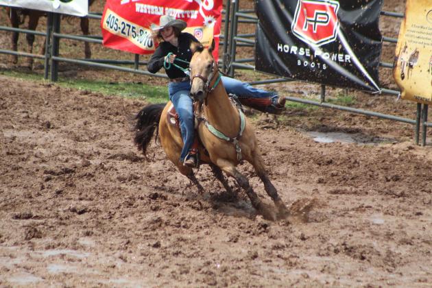 Megyn Alls of Shawnee makes a wide turn around the first barrel during of the International Finals Youth Rodeo on the morning of July 11.