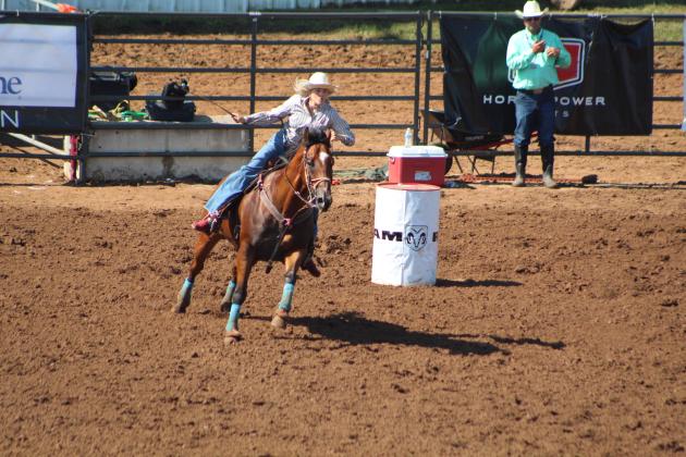 Madison Van Brunt of Shawnee coaxes her horse to go faster as she finishes the Barrel Riding event of the IFYR on the morning of July 10. Countywide &amp; Sun/Natasha Dunagan