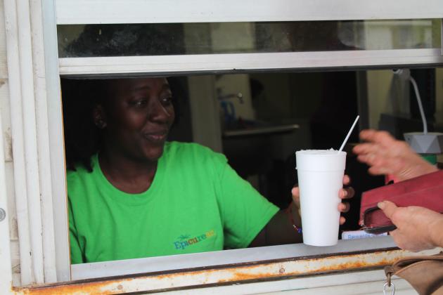 Tarryn Henry at Epic Sno Cones serves a cup of shaved ice.