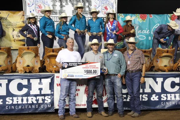 Mason Stueve of Newton, KS, earned All-Around Cowboy at the International Finals Youth Rodeo. He made a combined $8,784 in Calf Roping and Team Roping, according to the IFYR website. Here, he accepts a bonus check of $500 from Dwight Yancey with Shawnee Dry Cleaners, left. He also received a trailer from NTS Trailers, whose two representatives are at right, as well as a saddle and a belt buckle on July 14. Countywide &amp; Sun/Natasha Dunagan
