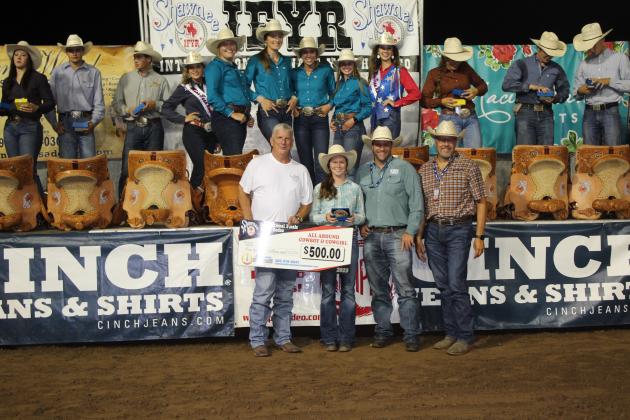Brooke Crenshaw of Colbert, OK, earned All-Around Cowgirl at the International Finals Youth Rodeo. She made a combined $8,039 in the Pole Bending and Breakaway events, according to the IFYR website. Here, she accepts a bonus check of $500 from Dwight Yancey with Shawnee Dry Cleaners, left. She also received a trailer from NTS Trailers, whose two representatives are at right, as well as a saddle and a belt buckle on July 14. Countywide &amp; Sun/Natasha Dunagan