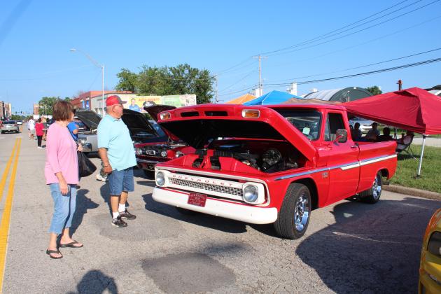 Linda and H.L. Watkins of OKC look over a 1966 Chevrolet C-10 owned by Randy Schultz of Shawnee during the Downtown at Sundown Car Show on July 15. This was the fourth annual car show presented by Downtown Auto Body and DTAB Customs, and there were about 300 cars entered, said Tommy Hibben with the business. The event was held  on Main Street in Shawnee, between Beard and Kickapoo streets, and there was live music by Nasty Weather, games, prizes, giveaways and food trucks.