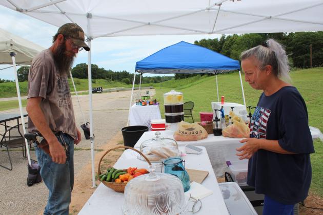 Tristan and Jennifer Hoke look over a variety of peppers from their garden.