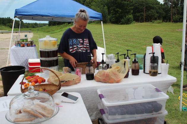Jenifer Hoke arranges things at her booth.