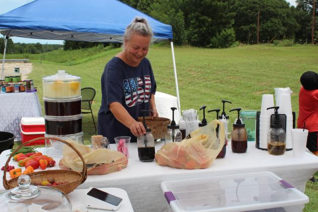 Jenifer Hoke arranges things at her booth.
