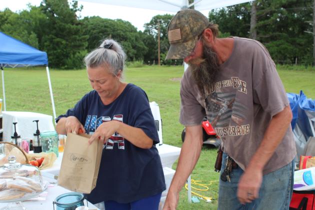 Jenifer and Tristan Hoke bag tomatoes for a customer.