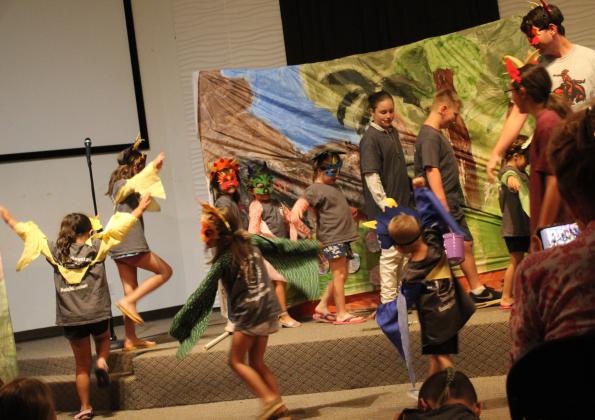 The youngest students in Macomb's Summer School program perform the "Dinosaur Dance" in their play, "Attack of the Evil Bugs," at the Student Center on July 13.