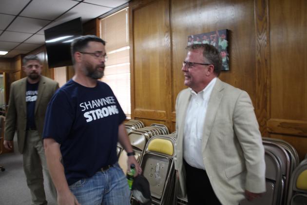 Shawnee Board of Education President Clif Harden talks with new Executive Director of Operations Ron Stearns.