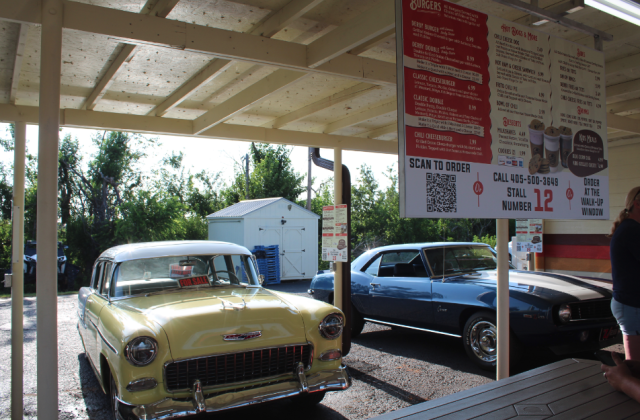 A 1955 Chevrolet Belair, owned by J.R. Lloyd of Shawnee, and a 1969 Chevrolet Camaro, belonging to Shane and Vivian Brown of Shawnee, were two of the vehicles at the monthly Cruise the Poo 2.0 on July 29. They met at The Brown Derby, which reopened on July 26 after recovering from tornado damage. Their original radios could not be replaced, so orders will now be taken using a QR Code, by phone or at the walk-up window, as seen on menus in front of each stall.