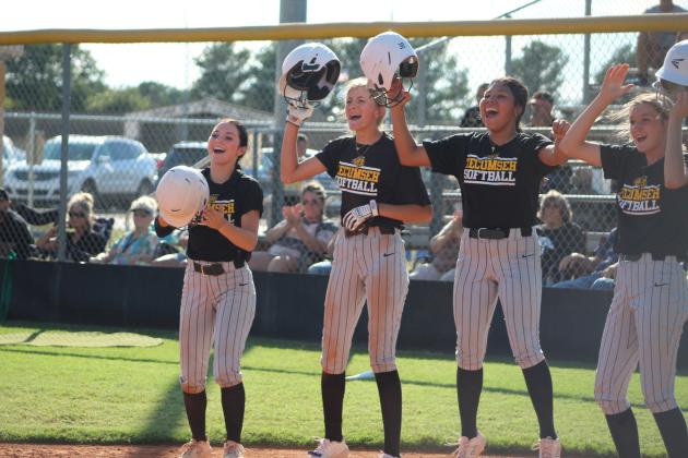 Waiting at home plate, four of the Tecumseh Lady Savages cheer on junior Katie Overstreet after she hit a home run on Aug. 14. The THS fast pitch team won over Cleveland, 17-0. Countywide &amp; Sun/Natasha Dunagan