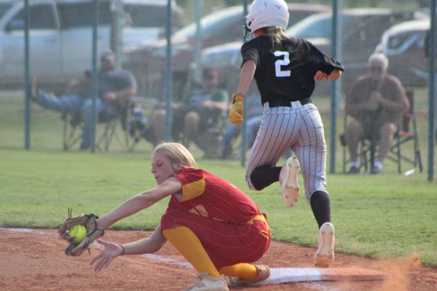 Tecumseh sophomore Blakelee Parker runs across first as a Cleveland player makes the catch during the home game on Aug. 14. Countywide &amp; Sun/Natasha Dunagan