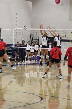 Shawnee's Chrishelle Milum (#4) and Mikah Teape (#19) prepare to block in their third game against Duncan on Aug. 24. The varsity volleyball team is playing at the Shawnee Middle School gym this year due to tornado damage at the Performing Arts and Athletic Center. They lost, 0-3. Countywide &amp; Sun/Natasha Dunagan