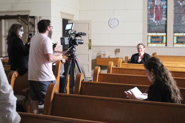 Dead End Film House Director Jeff Richardson records as actress Grace Black, background, goes through “sadness” for the short, silent film, “Seance.” Black was acting out each of the emotions. The OKC-based company was filming at the Broadway Chapel in Tecumseh on Sept. 8, after finding the location through venue owner Dennis Dyer. Also shown is actor, Jordy Branam, far left. Countywide &amp; Sun/Natasha Dunagan