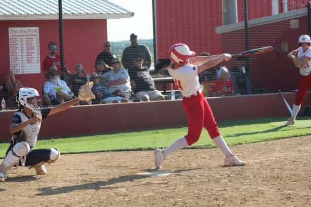 Dale's Karsen Griggs hits a home run, as Bethel catcher Layla Menhusen stands ready during the Aug. 31 game at Dale. The Lady Pirates won 12-0. Countywide &amp; Sun/Natasha Dunagan