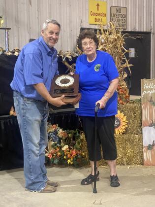 Pottawatomie County Free Fair Board Vice Chairman Matt Griffith presents Gloria Crosby with an appreciation award for her 53 consecutive years of volunteering at the fair. Photo provided