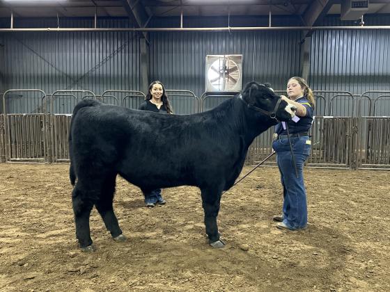 Olivia Rawlins, of Tecumseh FFA, poses with her Reserve Grand Champion Steer during the Beef Show of the Pottawatomie County Free Fair on Sept. 8. Also shown is Livestock Judge Eva Hinrichsen. Photo provided by Fair Manager Amy Hasbell.