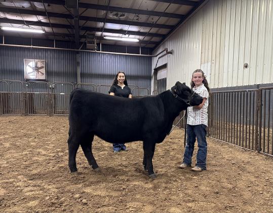 Taycie Baker, of Dale 4-H, poses with her Supreme Grand Champion Heifer during the Beef Show of the Pottawatomie County Free Fair on Sept. 8. Also shown is Livestock Judge Eva Hinrichsen. Photo provided by Fair Manager Amy Hasbell.