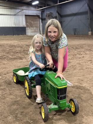 Abby, 3, and Rachel Townsend, 8, both of Tecumseh, participate in the Pee Wee &amp; Midget Tractor Operator Contest on Sept. 8 during the Pottawatomie County Free Fair. Photo provided by Fair Manager Amy Hasbell.