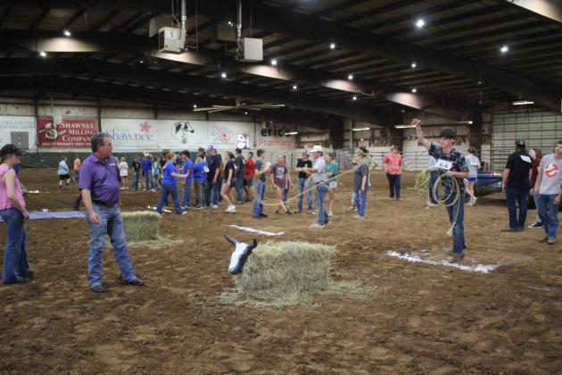 Bethel freshman Jacob Ratcliff tosses his rope in the dummy steer roping event during Farmhand Olympics on Sept.6, as Farm Bureau volunteer Todd Colburn and Baylee Weeks watch. Countywide &amp; Sun/Natasha Dunagan