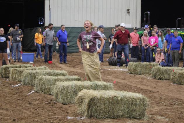 Bethel freshman Rianne Tinsley does the sack race portion of the Farmhand Olympics relay on Sept. 6. Countywide &amp; Sun/Natasha Dunagan