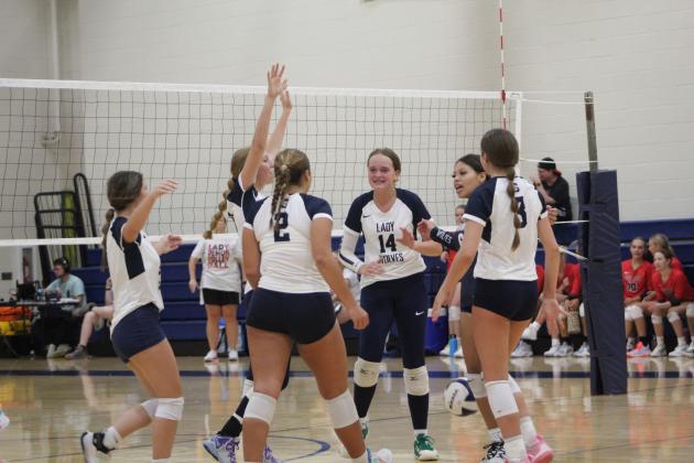 The Shawnee Lady Wolves celebrate a point in their third game against Duncan on Aug. 24. The varsity volleyball team is playing at the Shawnee Middle School gym this year due to tornado damage at the Performing Arts and Athletic Center. They lost, 0-3. Countywide &amp; Sun/Natasha Dunagan