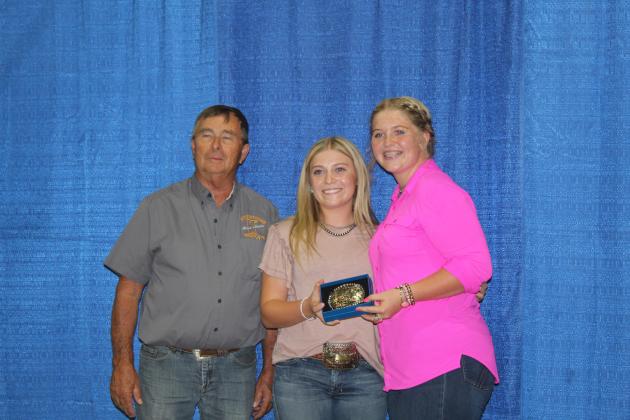 Pottawatomie County Fair Board Member Lynn Marlow poses with Berklee Gossen, of NRC FFA, and Josey Milburn, of Asher FFA, who tied for the High Point Meat Goat Buckle on Sept. 9. Gossen won in Division 5 Does and the Senior Showmanship for Meat Goats, and Milburn won in Division 1 and Division 4 Does, Reserve Grand Champion Doe and Intermediate Showmanship. Countywide &amp; Sun/Natasha Dunagan