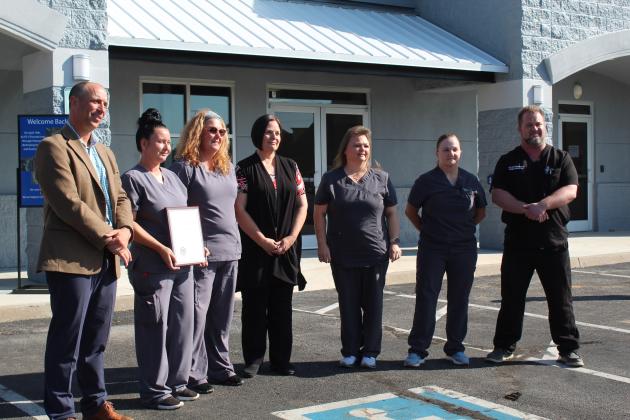 OKC VA Health Care System Director Wade Vlosich presents a plaque of recognition to the staff of the Shawnee VA Clinic for their work during the April 19 tornado aftermath, during their Grand Reopening on Sept. 18. Shown, from left, are Vlosich, Janelle Oldham, Becky Vanworth, Sara Hatcher, Valinda Shelton, Tamatha Perkins and Dirk Lenaburg. Countywide &amp; Sun/Natasha Dunagan
