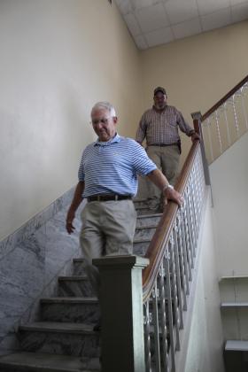 Shawnee Veterans Memorial Committee President Bill Ford and Pott. County Facility Maintenance Technician Thad Campbell descend the marble stairs of the former District Attorney's Office on Sept. 5. The committee toured the old Carnegie Library, as approved by the County Commissioners, in hopes of making it a Veterans Museum. Countywide &amp; Sun/Natasha Dunagan