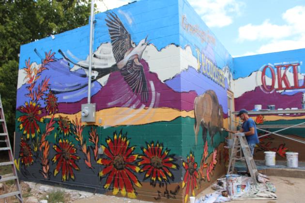 Shane Cox assists Bob Palmer with a mural on the west side of 421 E. Walnut in Tecumseh on Oct. 11. Countywide &amp; Sun/Natasha Dunagan