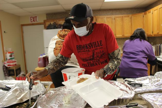 Clarence Cooks, Jr. prepares a to-go box.