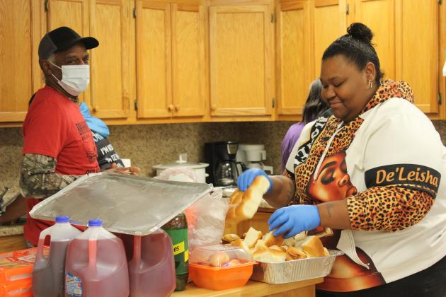 Clarence Cooks, Jr. and De'Leisha Phillips prepare for the potluck dinner at the Brooksville 120th Celebration.