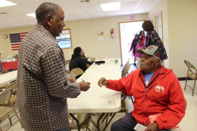 Leonard Phillips, right, sells Bobby Jackson a T-shirt.