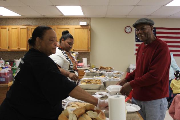 Frances Phillips and De'Leisha Phillips serve Billy "Bobby" Cooks in the potluck line during the Brooksville 120th Year Celebration, held at the Brooksville Community Center on Oct. 14. Cooks grew up in Brooksville, and his father, Arthur Cooks, owned a grocery store there. Countywide &amp; Sun/Natasha Dunagan
