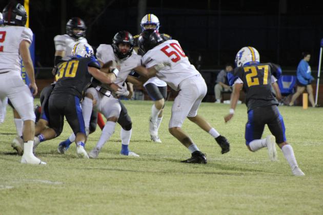 Bethel senior Gabriel Palomares (#30) and several other Wildcats try to tackle the Crossings Christian ball carrier at the homecoming game on Oct. 20. The Wildcats lost, 26-39. Countywide &amp; Sun/Natasha Dunagan