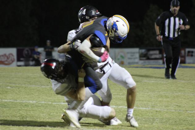 Two Crossings Christian Knights try to take down Bethel sophomore Luke Quinter during the homecoming game on Oct. 20. The Wildcats lost, 26-39. Countywide &amp; Sun/Natasha Dunagan