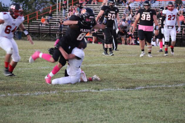 Maud junior Trustin Smith is tripped up by a Fox defender in the Pink Out Homecoming game on Oct. 5. The Maud Tigers won, 50-0. Countywide &amp; Sun/Natasha Dunagan