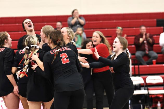 The Lady Cougars celebrate match point. Photo courtesy of Gowin Photography