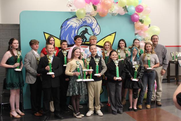 Farm Bureau Representative Josh Grundmann, far right, presents several 4-H Club members with Farm Bureau High Point Awards for their success in the Pottawatomie County Free Fair during the 4-H Awards Banquet, held at the North Rock Creek High School Cafeteria on Oct. 23. Shown, not in order, are Legend Baker, Taycie Baker, Tony Nelms, Jessilynn Kuchynka, Emily Davis, Gabe Hobbs, Mason Luka, America Sandifer, Tori Nelms, Andrew Collins, Kimberly Holland, Taylor Marrs, Megyn Alls and Emma Collins.