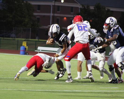 Shawnee junior Jamir Owens carries the ball and squeezes between two John Marshall defenders during the Homecoming game held at OBU on Oct. 6. The Wolves won, 37-0. Countywide &amp; Sun/Natasha Dunagan