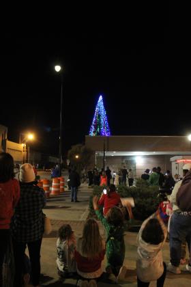 Children jump up and clap after the Shawnee Tree is lit on top of the Pioneer Library on Nov. 17. Countywide &amp; Sun/Natasha Dunagan
