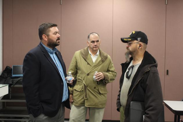 Navy veteran Jeremy Roberts, far right, speaks with representatives from Veterans Upward Bound, Cody Dildine and Bob Keel, during the Oklahoma Employment Security Commission Veterans/Community Job Club on Nov. 2 at Gordon Cooper Technology Center. Veterans Upward Bound is based at East Central University, but helps veterans get into the college of their choice. Countywide &amp; Sun/Natasha Dunagan